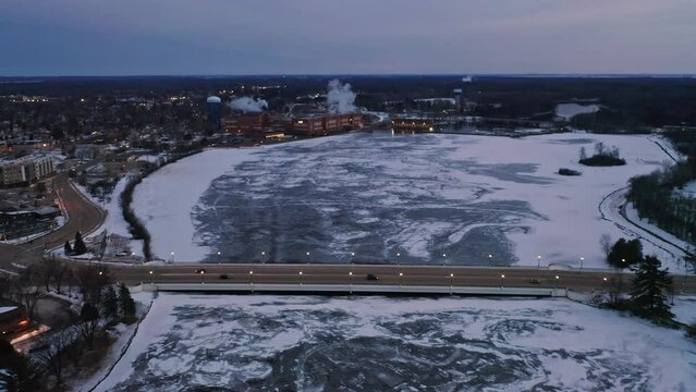 Aerial, Stevens Point during winter, frozen Wisconsin River in the evening