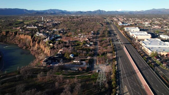 Redding, California with Sacramento River, Highways, Mountains in the distance. Suburban USA, 4K drone shot.