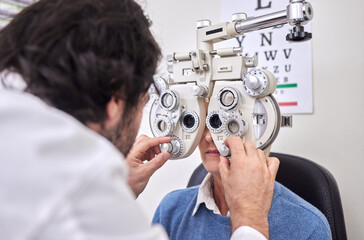 Eye care, test or exam for patient and doctor AT optometry consultation for lens or frame for vision. Woman and man healthcare person with machine for eyes, eyesight and health insurance examination