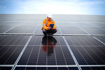 Solar energy industrial worker doing quality control of photovoltaic panels installed on the...
