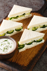 Cucumber Sandwich With Creamy Dill Spread closeup on the wooden board on the table. Vertical