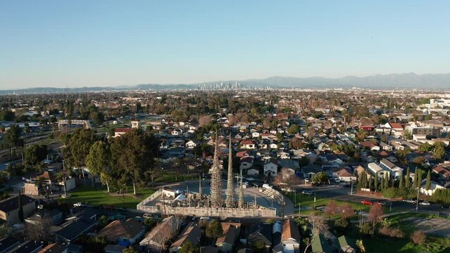 Wide push-in aerial shot of the Watts Towers in Los Angeles, California. 4K