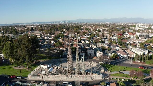 Aerial push-in and tilting down shot of the Watts Towers in Los Angeles, California. 4K