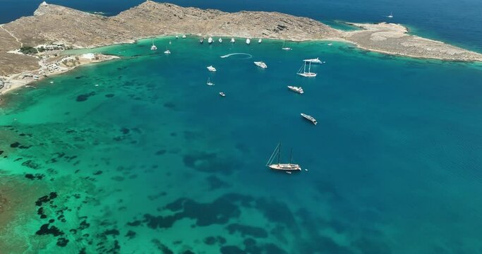 Birds eye view above a secluded cove with yachts in Paros, Greece.