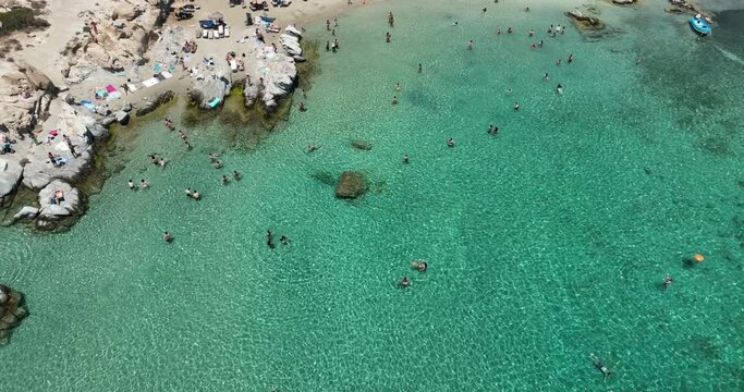People swimming at the beach in Paros Greece.