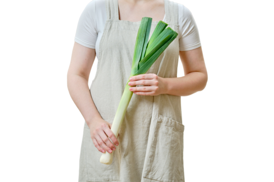 A woman holds a leek in her hands standing on a home kitchen, close-up, isolated on a white background
