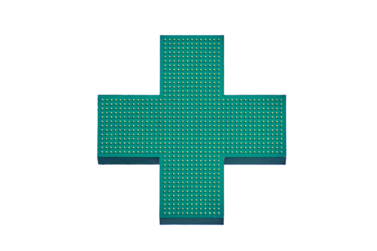 Green cross of a pharmacy store on the wall of a building, isolated on a white background