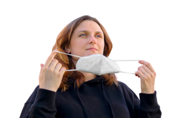 Adult woman take off medical face mask, on background theater. Attending holidays and public show after the end of the, isolated on a white background