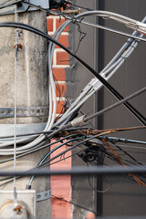 Numerous wires tangled in complexity on a telephone pole.