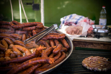 An outdoor food stall selling grilled homemade sausages