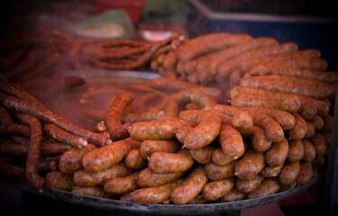 An outdoor food stall selling grilled homemade sausages