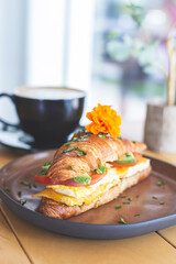 Croissant filled with avocado, tomato and egg
