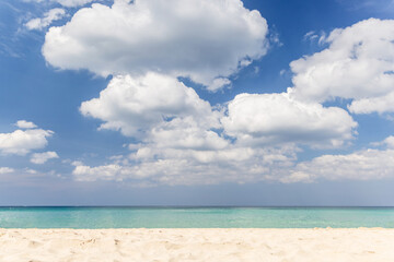 Bright sand beach, sea and beautiful sky with clouds