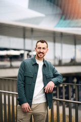 Fototapeta premium Vertical portrait of happy handsome smiling man looking at camera