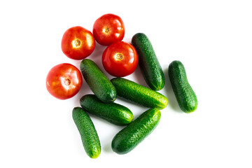 plan view of green fresh cucumbers and red tomatoes isolated on white background