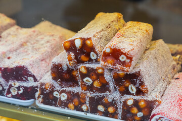 Eastern sweets. Traditional Turkish baklava with hazelnuts Arabian dessert, baklava, halva, Turkish delight in briquettes on a shop window