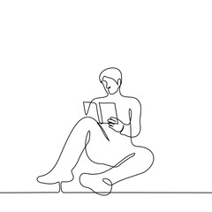 man sits with a book on the floor or on the ground - one line drawing vector. the concept of reading a paper book, leisure or hobby, book lover or student studying from a textbook