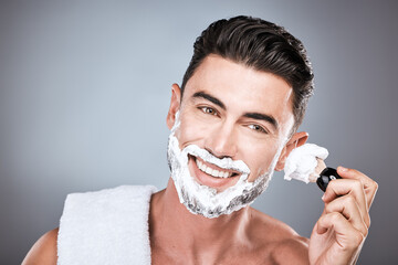 Brush, shaving cream and face of man in studio isolated on a gray background for hair removal....