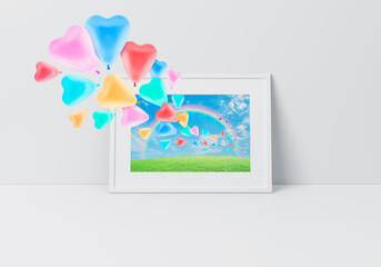 Colorful love heart balloon with green grass field over blue sky, rainbow and birds on poster in horizontal white frame on floor over grey wall, Valentines day concept, 3D rendering