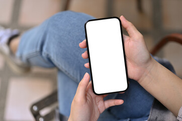 Top view of a female using her smartphone while relaxing in the backyard. phone mockup