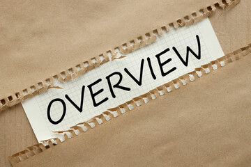 OVERVIEW . text on white paper on craft paper background