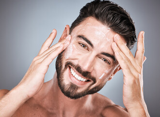 Skincare, face and man with cream in studio isolated on a gray background for facial wellness....
