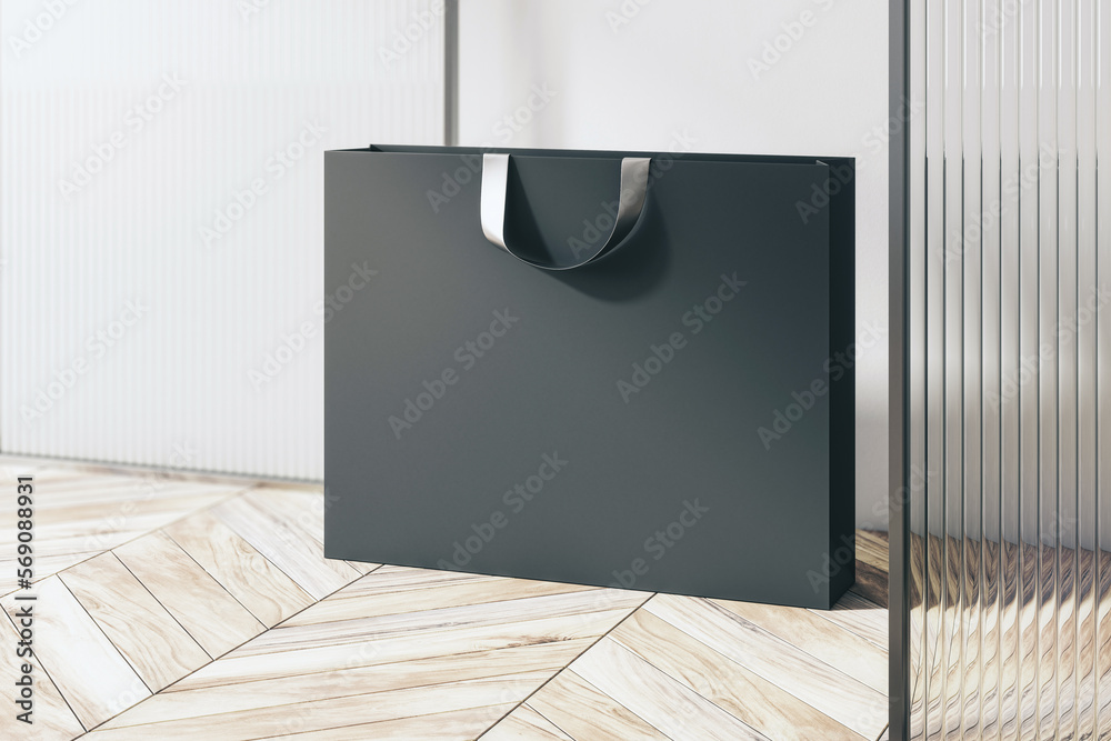 Poster perspective view on blank black paper shopping bag with place for your brand name or text on light w