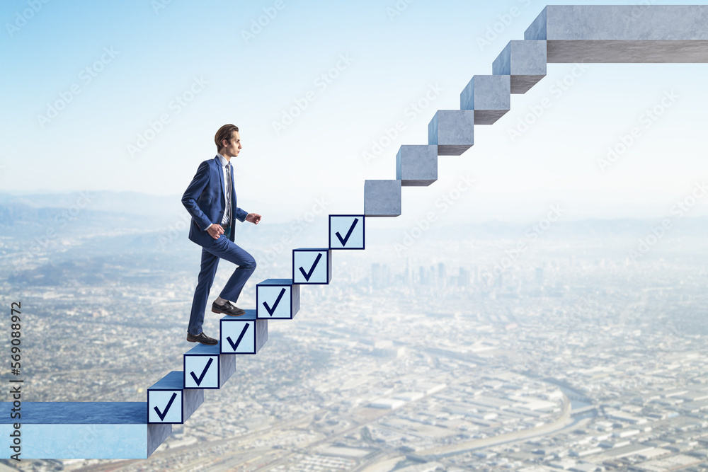 Poster side view of young businessman getting work down while walking up on concrete stairs with ticks on b