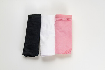 folded set of colorful cotton panties on a white background. the concept of classic underwear made of natural fabrics.