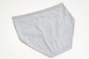 rear view. a gray cotton panties on a white background. the concept of classic underwear made of natural fabrics.
