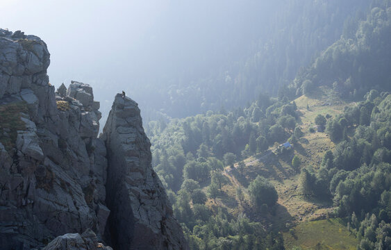 View of hiker seen climbing up over peak of Martinswand mountain, Hohneck, Vosges, France