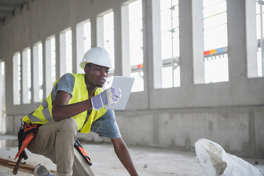 Construction worker using digital tablet at building site