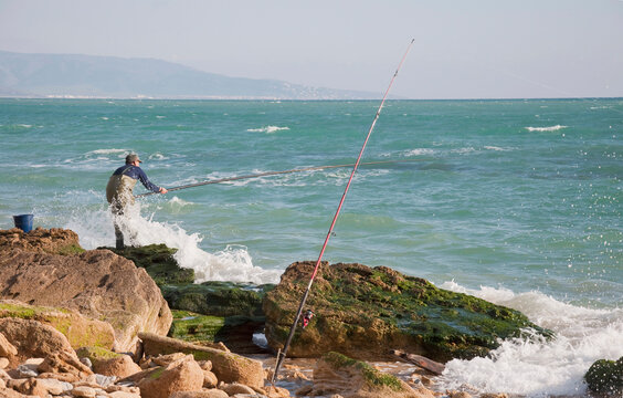 View of fisherman at beach near atlantic ocean