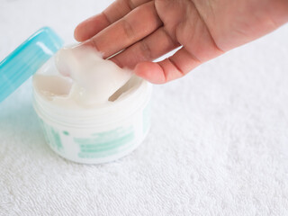 Hand Woman Holding Cream Lotion on White Towel Background,Spa Beauty Mask Moisturizer  for Face after Shower Water,Serum Cosmetic Medicine Care Body Herbal Nature for People.