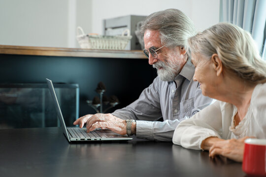 Senior Couple Working And Checking Personal Finances With Laptop At Home.