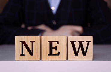 The word "New" written on wood cube. Business concept