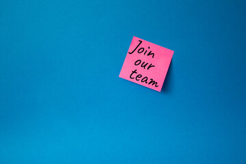 Join our team symbol. Concept words Join our team on pink steaky note. Beautiful blue background. Business and Join our team concept. Copy space.