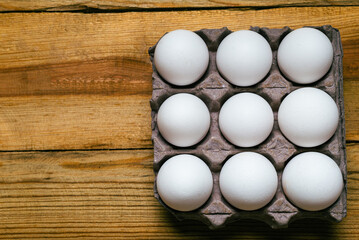Group of eggs on wooden table. Top view.