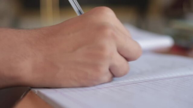 Shot of Human hand writing on a piece of paper with a black colored pen, Hd footag