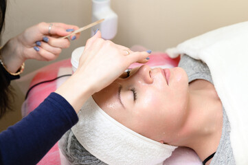 Applying cream and rubbing into the skin, cosmetology relaxing procedure.