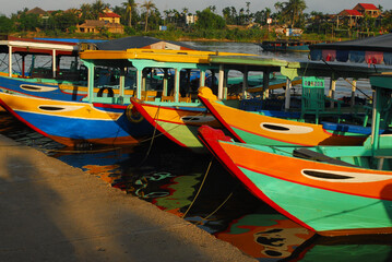 Colorful tourism boats with painted eyes on bow - Vietnam