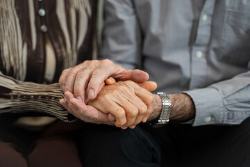 Close up mature spouses holding hands,Support,Couple hands holding in love and comfort together in the hope of unity.