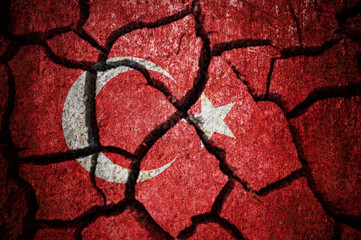 Earthquake in Turkey. Turkey flag on the cracked earth. Cracked Turkey flag.