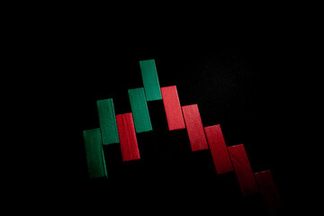 Financial chart made of small wooden blocks on a black background