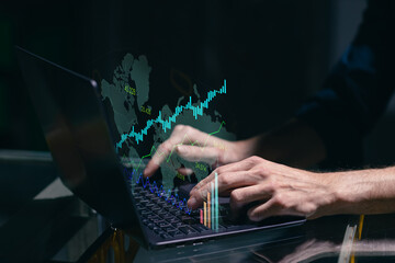 Virtual laptop computer screen with chart graph on world map and businessman hands working on new business finance strategy concept