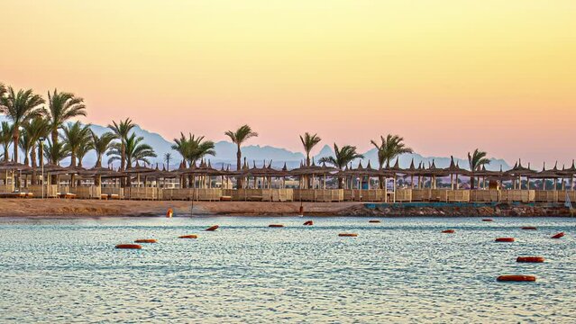 Timelapse of a beach in Hurgada, Egypt with patios and palm trees, no people