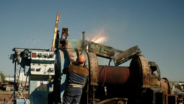 Metal Torcher Working on a big Piece of Machinery 