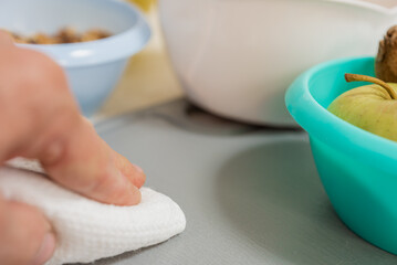 Closeup photo of male cook wiping cutting board after cooking