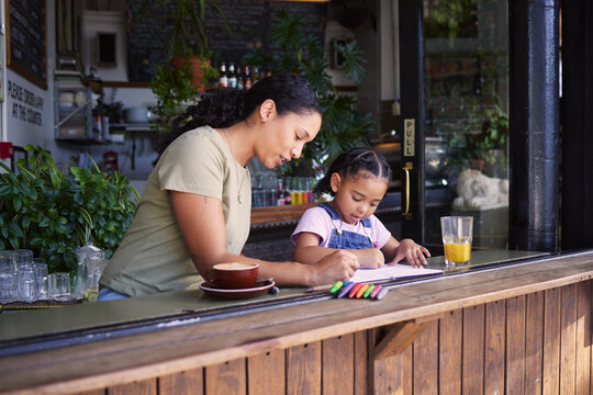 Coffee Shop, Black Family And Crayons With A Mother And Daughter Coloring A Book At A Cafe Window Together. Art, Creative And Love With A Woman And Happy Female Child Bonding In A Restaurant