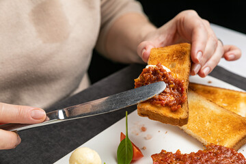delicious tartar on a white plate with croutons
